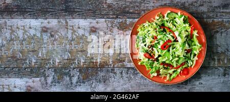 Healthy vitamin salad with fresh cabbage. Spring salad with cabbage and herbs. Healthy diet. Immunity diet. Stock Photo