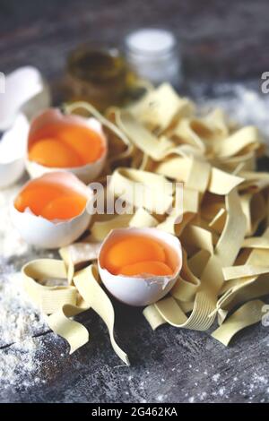 Raw noodles, eggs, flour. Egg noodles. Stock Photo