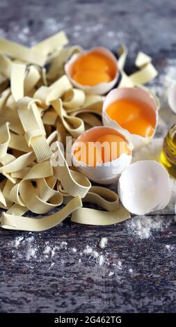 Raw noodles, eggs, flour. Egg noodles. Stock Photo