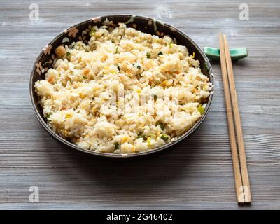 chinese cuisine - yangzhou fried rice in ceramic plate on wooden table Stock Photo