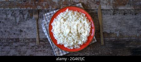 Cottage cheese on an orange plate. Stock Photo