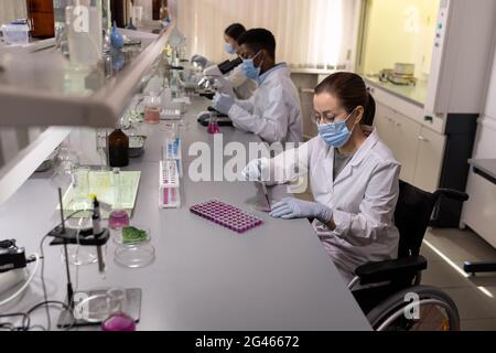 Female chemist working with liquid substances in laboratory Stock Photo