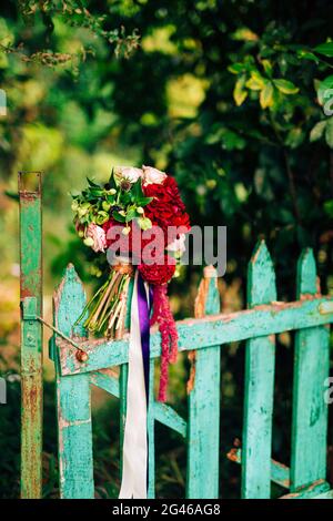 Wedding bridal bouquet of roses, celosia, Proteus on the green w Stock Photo