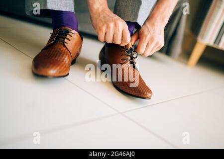 The man in gray slacks and a purple dress socks brown shoes with Stock Photo