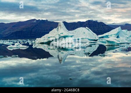 The reflection of an isolated iceberg on the lagoon of Jokulsarlon, Iceland Stock Photo