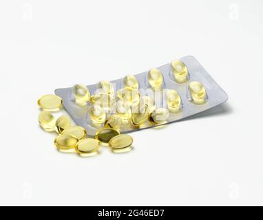 Fish oil in capsules and blister pack on white background, food supplement for health Stock Photo