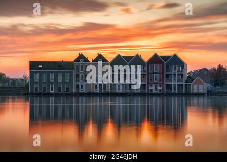 The famous rainbow houses of Houten in Holland after sunset . Stock Photo