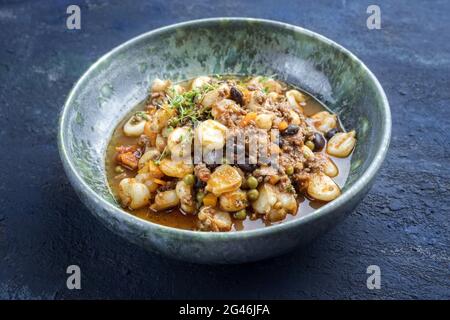 Modern style traditional slow cooked Mexican pozole rojo soup with ground minced beef Stock Photo