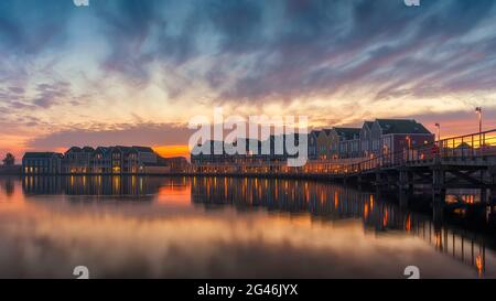 The famous rainbow houses of Houten in Holland after sunset . Stock Photo