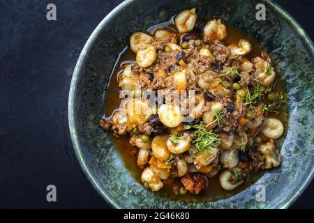 Modern style traditional slow cooked Mexican pozole rojo soup with ground minced beef Stock Photo