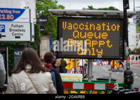 London, UK.  19 June 2021.  A sign directing people to a mass vaccination centre at Stamford Bridge, the home of Chelsea FC, as the capital aims for 100,000 doses administered per day.  West Ham, Charlton and Tottenham Hotspur are other London football clubs offering walk-ins. With cases of the Delta variant increasing, the UK government has invited all over 18s for a Covid-19 vaccination in an effort to have as many people to be vaccinated by July 19th, the revised date when all lockdown restrictions are relaxed.  Credit: Stephen Chung / Alamy Live News