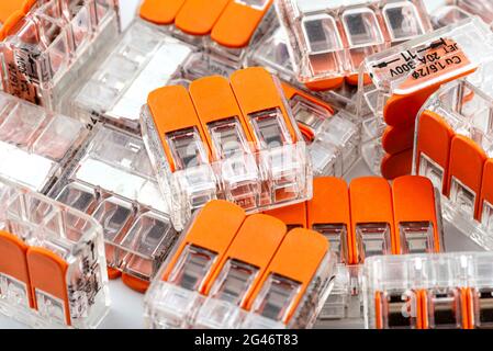 Background made of multiple couplers for strands and solid conductors for electric cables, isolated on white background. Stock Photo
