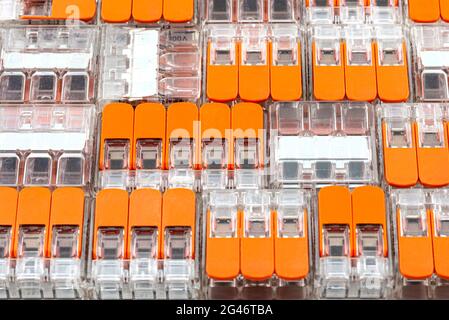 Background made of multiple couplers for strands and solid conductors for electric cables. Stock Photo