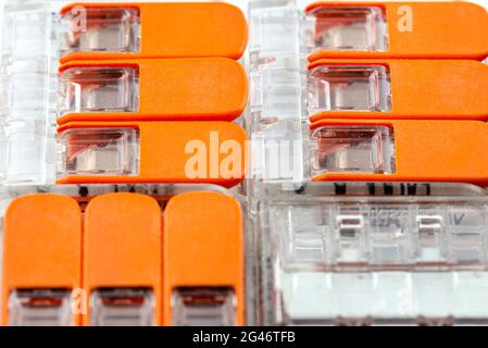 Background made of multiple couplers for strands and solid conductors for electric cables. Stock Photo