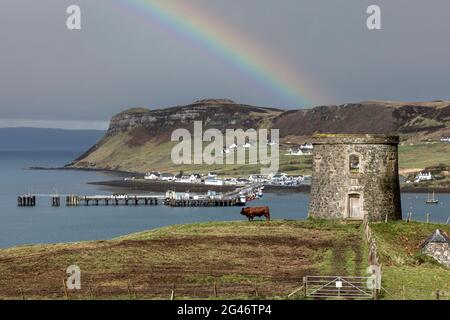 uig isle of skye in storm lighting with rainbow and folly tower Stock Photo