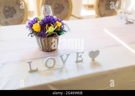Flower compositions on the wedding table in rustic style. Wedding decorations with their own hands. Stock Photo