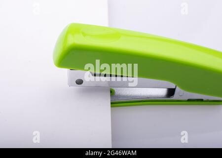 Closeup shot of a green stapler on a white background Stock Photo