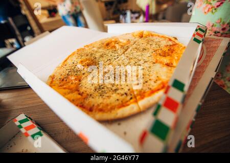 Girls in dressing gowns ordered pizza Stock Photo