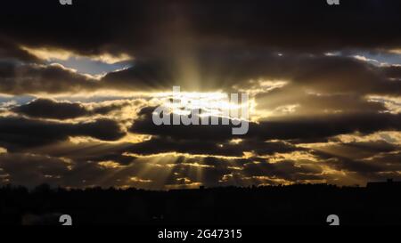 Blue sky and dark clouds with sunlight Stock Photo