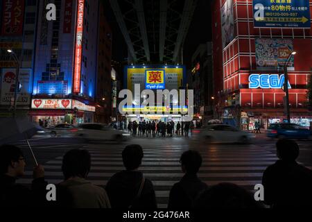 People waiting to cross the road in Akihabara, Tokyo Stock Photo