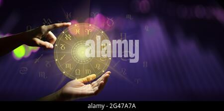 Human predicts the future. Zodiac sign wheel of fortune hologram with mandala inside. Deep green and life graph background. Copy space. Stock Photo