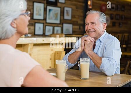 Senior couple interacting while having coffee Stock Photo