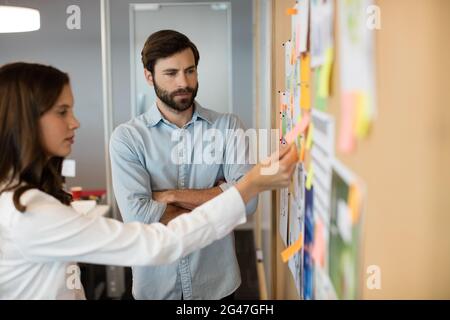 Serious business colleagues analyzing charts in office Stock Photo