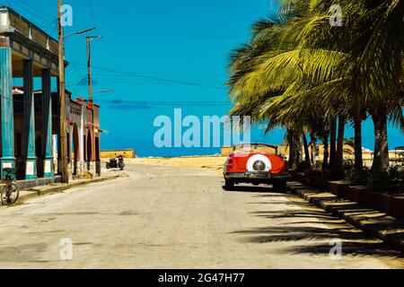 A classic American car parked on a quiet street in the the sleepy coastal town of Gibara, Holguin Province, Cuba Stock Photo