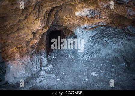 Abandoned adit interior. Dark tunnel of old magnesium mine Stock Photo