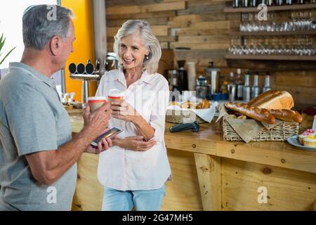 Senior couple interacting with each other while having coffee Stock Photo