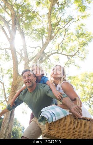 Family arriving in the park for picnic on a sunny day Stock Photo