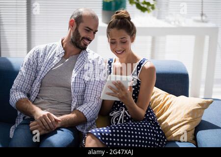 Male and female executives using digital tablet on a sofa Stock Photo