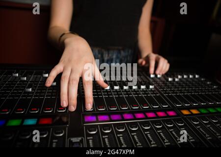 Mid-section of female audio engineer using sound mixer Stock Photo