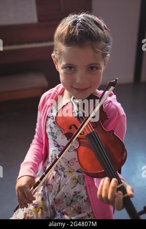Portrait of a girl playing the violin outdoors, Close up of a girl with ...