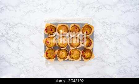 Flat lay. Step by step. Cooling freshly baked cranberry muffins. Stock Photo