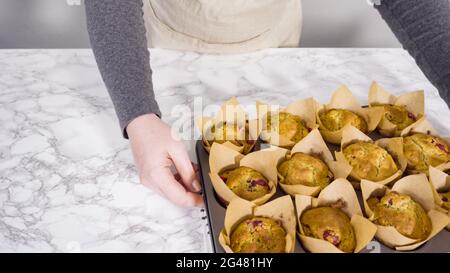 Step by step. Cooling freshly baked cranberry muffins. Stock Photo