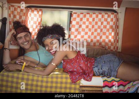 Portrait of happy friends lying down in van Stock Photo