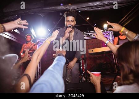 Portrait of male singer performing on stage during music festival Stock Photo