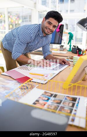 Male graphic designer working at desk Stock Photo