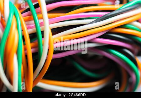 A bundle of multicolored electrical, car, computer, telephone twisted wires. Stock Photo