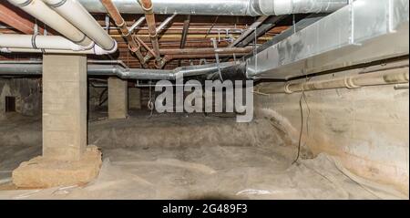 New construction rehab in the basement of a very old building with heating and air conditioning duct work. Stock Photo