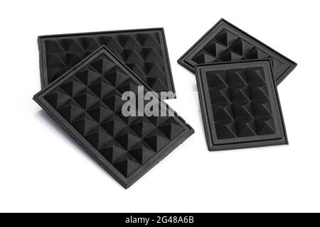 Black plastic leg on the bottom of the bag on a white background. Legs for travel bags made of plastic, embossed. Stock Photo