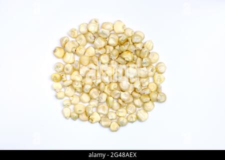 Dry grains of corn on a white background. Yellow grains of corn top view. Seeds for planting in the ground. Stock Photo