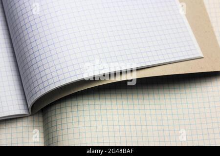 Opened notepad notebook with checkered sheets. Blank sheet in a cage. School. Stock Photo