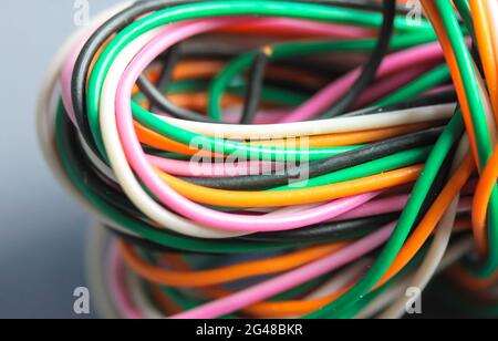 A bundle of multicolored electrical, car, computer, telephone twisted wires. Stock Photo