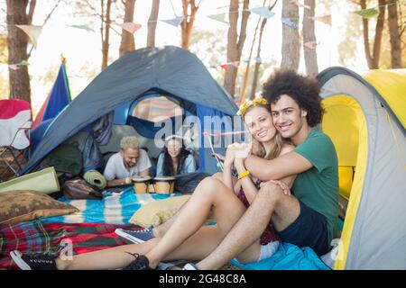 Portrait of smiling couple in tent Stock Photo