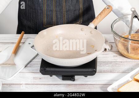 Frying french toast in a nonstick frying pan. Stock Photo