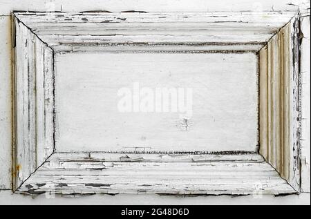 A white door panel with old weathered and cracked paint Stock Photo