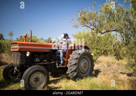 Man using virtual reality headset in tractor Stock Photo