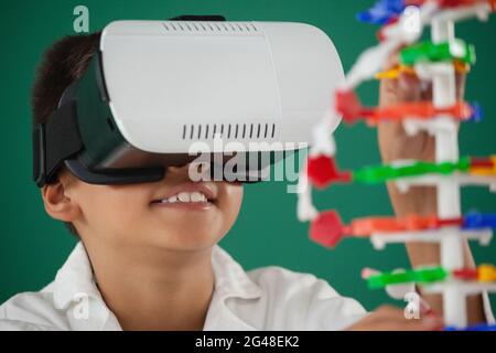 Schoolboy using virtual reality headset in laboratory Stock Photo